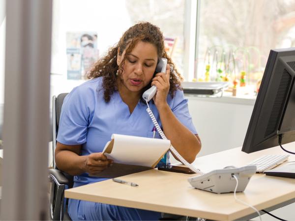 Lady at the desk answering the phone 