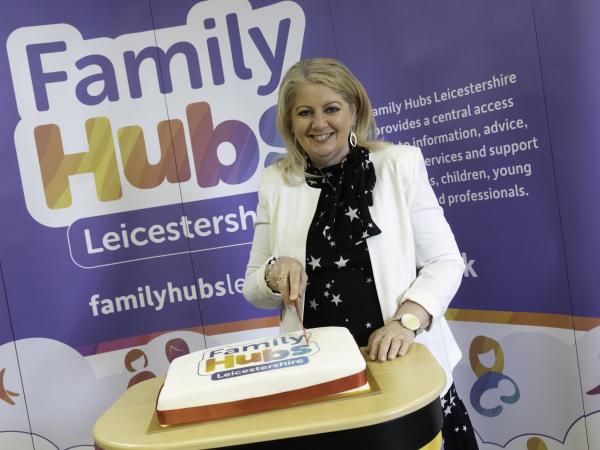 Image of Family Hubs opening, cutting the cake
