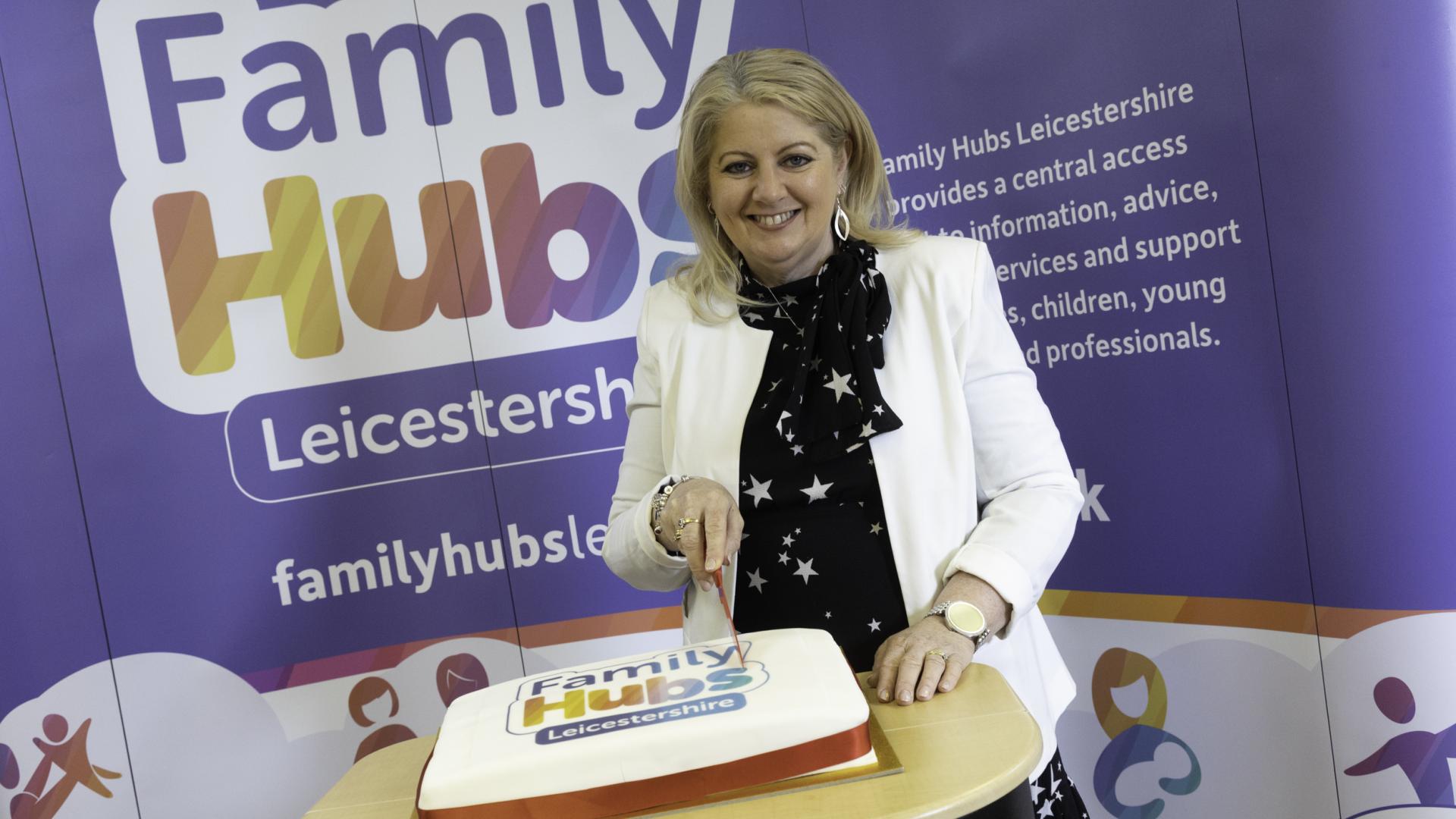 Image of Family Hubs opening, cutting the cake