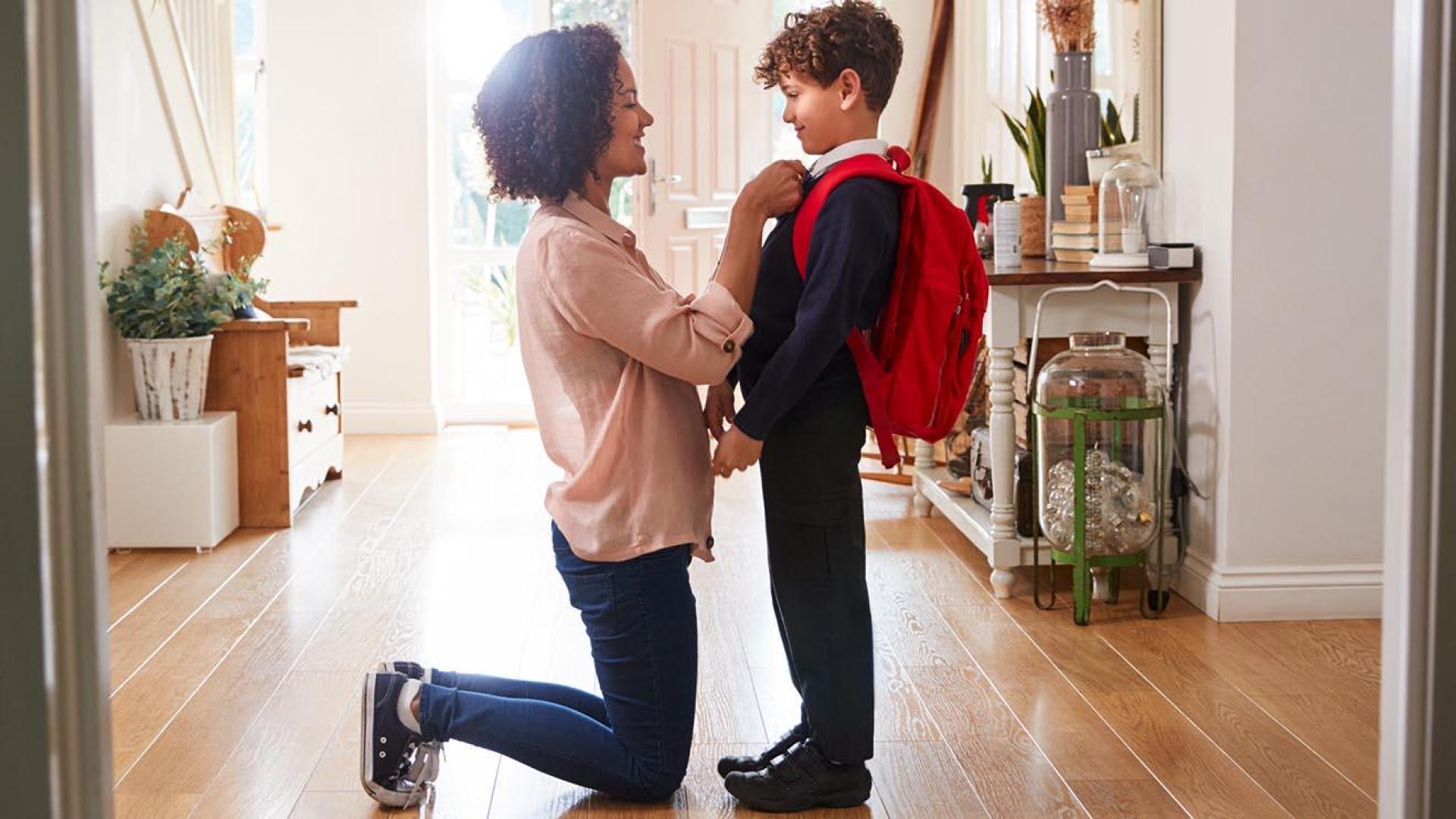 Image of a mum helping her little boy with his school uniform